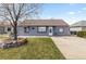 Charming single-story home with a well-maintained lawn and quaint landscaping at 4849 N Cook St, Denver, CO 80216