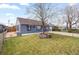 Inviting single-level home featuring a green lawn and mature tree in the front yard at 4849 N Cook St, Denver, CO 80216