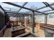 Enclosed greenhouse with black frame and raised garden beds for a vibrant gardening experience at 4849 N Cook St, Denver, CO 80216