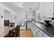 Well-lit kitchen offering white cabinets, black countertops, and wood flooring at 4849 N Cook St, Denver, CO 80216