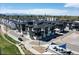 Aerial view of modern townhomes with garages, landscaping, and distant mountain views at 2042 S Holly St # 3, Denver, CO 80222