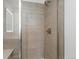 Modern bathroom features tiled walls, a glass shower door, and a rain shower head at 2042 S Holly St # 3, Denver, CO 80222
