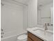 Bright bathroom featuring a shower-tub, a modern vanity, and white subway tiles at 2042 S Holly St # 3, Denver, CO 80222