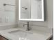 Modern bathroom vanity with sleek fixtures and bright, illuminated mirror at 2042 S Holly St # 3, Denver, CO 80222