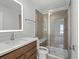 Bathroom with a walk-in shower, vanity, and integrated lighting for a luxurious experience at 2042 S Holly St # 3, Denver, CO 80222
