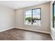 Spacious bedroom with hardwood floors and a large window at 2042 S Holly St # 3, Denver, CO 80222