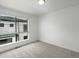 Airy bedroom featuring a large window, soft carpeting, and modern design elements at 2042 S Holly St # 3, Denver, CO 80222