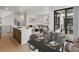 Stylish dining area adjoining the kitchen with modern table setting and balcony access to an outdoor living area at 2042 S Holly St # 3, Denver, CO 80222