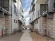 Perspective view between modern townhomes featuring stone accents, private entrances, and balconies at 2042 S Holly St # 3, Denver, CO 80222