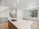 Open kitchen area with an island sink, stainless appliances, and modern staircase at 2042 S Holly St # 3, Denver, CO 80222