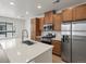 Modern kitchen with stainless steel appliances and a large island featuring a sink and views of an outdoor living space at 2042 S Holly St # 3, Denver, CO 80222