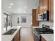 Bright kitchen showcases an island sink, stainless steel appliances, and wood floors at 2042 S Holly St # 3, Denver, CO 80222