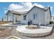 Inviting backyard features a concrete patio, fire pit, and built-in grill area perfect for outdoor entertaining at 1702 Metcalf Dr, Erie, CO 80516