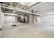 Spacious unfinished basement area with exposed ceiling beams, cement floor, and wall insulation at 1702 Metcalf Dr, Erie, CO 80516