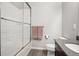 Bathroom showcases a white tiled shower with glass door, and a modern vanity with peach colored towels at 1702 Metcalf Dr, Erie, CO 80516