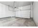 Spacious garage with an automatic door, painted walls, and a sealed cement floor at 1702 Metcalf Dr, Erie, CO 80516