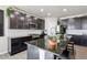 Spacious kitchen features an oversized island, granite countertops, stainless appliances and abundant dark cabinetry at 1702 Metcalf Dr, Erie, CO 80516