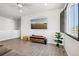 Cozy living room featuring sleek wood floors, built-in entertainment center, and contemporary design at 1702 Metcalf Dr, Erie, CO 80516