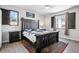 Main bedroom features rustic bedframe, ceiling fan and stylish windows allowing natural light at 1702 Metcalf Dr, Erie, CO 80516