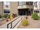 Inviting entrance with an accessible ramp, lovely landscaping, and the building number prominently displayed at 14091 E Marina Dr # 612, Aurora, CO 80014