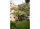 Exterior view of property with a blooming tree in foreground showing well maintained lawn and building facade at 14091 E Marina Dr # 612, Aurora, CO 80014