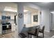 Well-equipped kitchen with stainless appliances, white cabinets, granite counters, and bar seating offers modern style at 14091 E Marina Dr # 612, Aurora, CO 80014