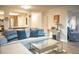 Inviting living room featuring a comfortable sofa, glass coffee table, and stylish decor, perfect for relaxation at 14091 E Marina Dr # 612, Aurora, CO 80014