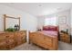 Bedroom with wooden bed frame, dresser and mirror at 39260 Braxton Ln, Elizabeth, CO 80107