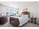 Bright bedroom with a large window, wooden sleigh bed, and dresser at 39260 Braxton Ln, Elizabeth, CO 80107