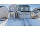 Two-story house with gray siding, stone accents, and a two-car garage at 39260 Braxton Ln, Elizabeth, CO 80107
