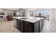 Kitchen island with dark brown cabinets and white quartz countertops at 39260 Braxton Ln, Elizabeth, CO 80107