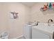 Bright laundry room with washer, dryer, and ample shelving at 39260 Braxton Ln, Elizabeth, CO 80107