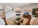 Living room with a fireplace, brown couches and a view of the stairs at 39260 Braxton Ln, Elizabeth, CO 80107