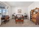 Sitting area featuring a brown couch, wooden furniture, and large windows at 39260 Braxton Ln, Elizabeth, CO 80107