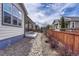 The backyard features a rock pathway and a wood fence at 7646 Greenwater Cir, Castle Rock, CO 80108