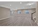 Finished basement with sleek flooring, recessed lighting, and multiple windows, ideal for flexible living or entertainment at 7646 Greenwater Cir, Castle Rock, CO 80108