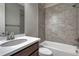 A tiled bathroom with a single vanity, a shower-tub combo, and neutral walls, offering a clean and functional space at 7646 Greenwater Cir, Castle Rock, CO 80108