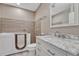 This bathroom features a walk-in tub, tile accents, and a marble countertop at 7646 Greenwater Cir, Castle Rock, CO 80108