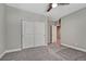 Comfortable bedroom featuring carpeted flooring, a ceiling fan, and closet space, offering a cozy and functional design at 7646 Greenwater Cir, Castle Rock, CO 80108