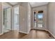 Inviting foyer with hardwood floors, natural light from the front door, and views of other rooms at 7646 Greenwater Cir, Castle Rock, CO 80108