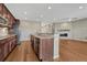 Open concept kitchen with a large island and stainless steel appliances overlooks living room with fireplace at 7646 Greenwater Cir, Castle Rock, CO 80108