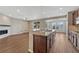 Kitchen island featuring stainless steel appliances and breakfast bar seating overlooking the fireplace at 7646 Greenwater Cir, Castle Rock, CO 80108