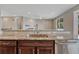 Granite countertop kitchen island with breakfast bar seating overlooking fireplace at 7646 Greenwater Cir, Castle Rock, CO 80108