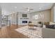 Open living room showcasing fireplace, neutral paint, and hardwood flooring at 7646 Greenwater Cir, Castle Rock, CO 80108