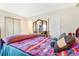 Well-lit bedroom featuring a dresser, closet and a warm interior at 13902 E Marina Dr # 111, Aurora, CO 80014