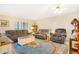 Living room with oversized furniture, ceiling fan, and an area rug adding warmth and charm at 13902 E Marina Dr # 111, Aurora, CO 80014