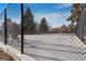 Fenced community tennis court on a sunny day at 13902 E Marina Dr # 111, Aurora, CO 80014