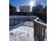 A fenced back deck is covered in snow, perfect for entertaining or enjoying the outdoors at 3610 Morning Glory Dr, Castle Rock, CO 80109