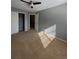 Bedroom with neutral carpeting, ceiling fan, and double closet at 3610 Morning Glory Dr, Castle Rock, CO 80109
