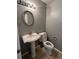 A convenient half bathroom features a pedestal sink, a toilet, and modern fixtures at 3610 Morning Glory Dr, Castle Rock, CO 80109